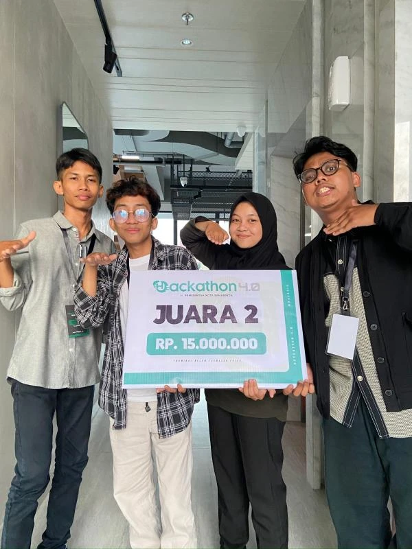 Hackathon team holding a second-place award sign after the 2024 competition.